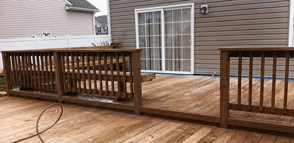 Deck sealing service protecting a backyard wood deck and railings in Denver, CO