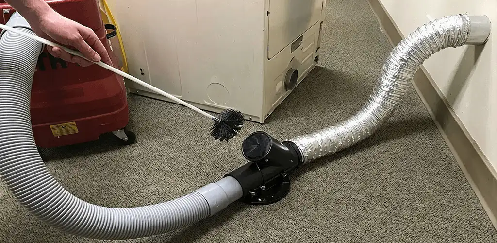 Dryer vent cleaning service removing lint from a dryer duct connection in Denver, CO