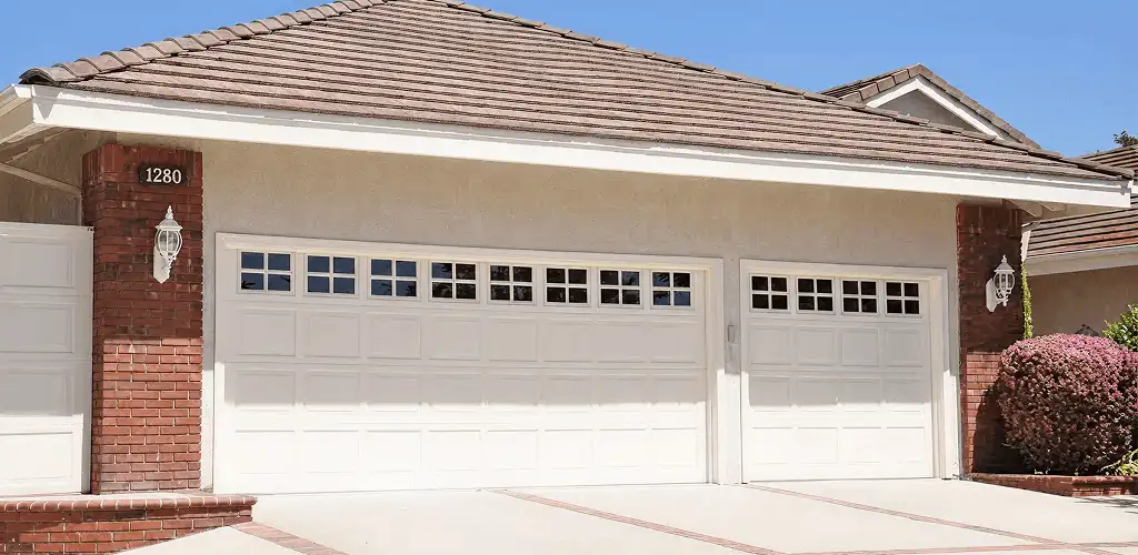 Residential garage door repair service for a double garage door in Denver, CO