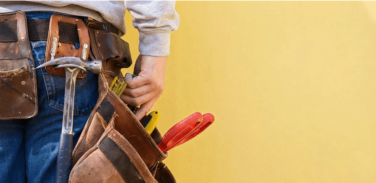Handyman with tool belt ready for home repairs and maintenance in Denver, CO
