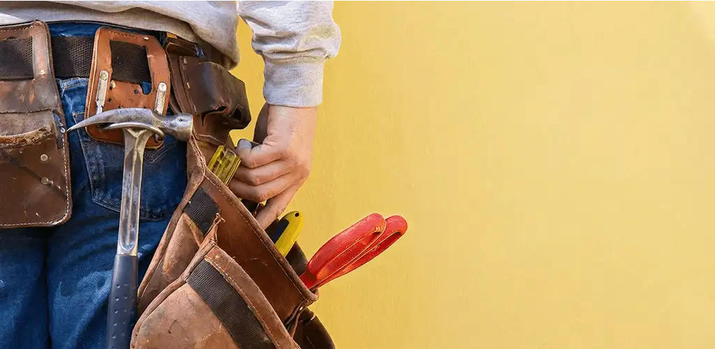 Handyman with tool belt ready for home repairs and maintenance in Denver, CO