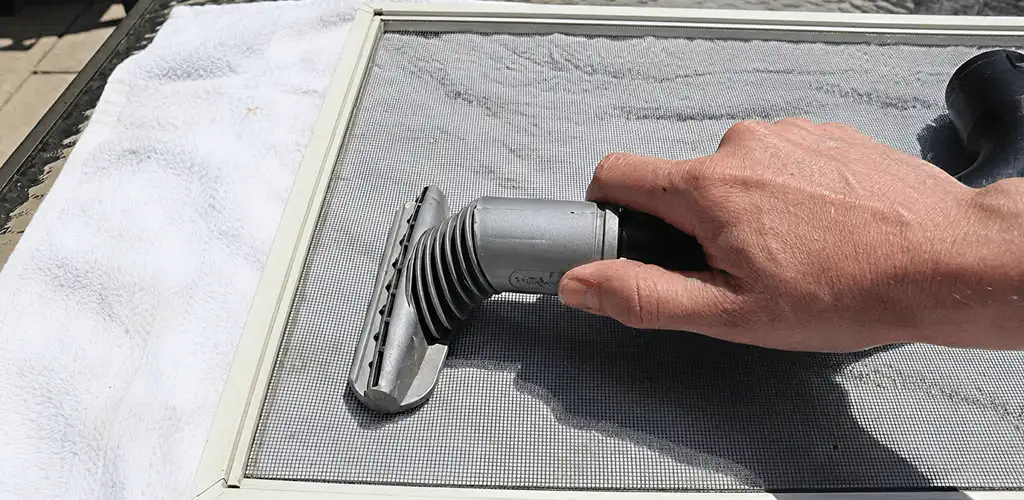 Window screen repair cleaning and fixing a damaged screen mesh in Denver, CO